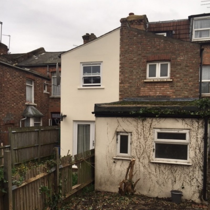 Conversion of dwellinghouse into two flats, single story infill extension, roof alterations